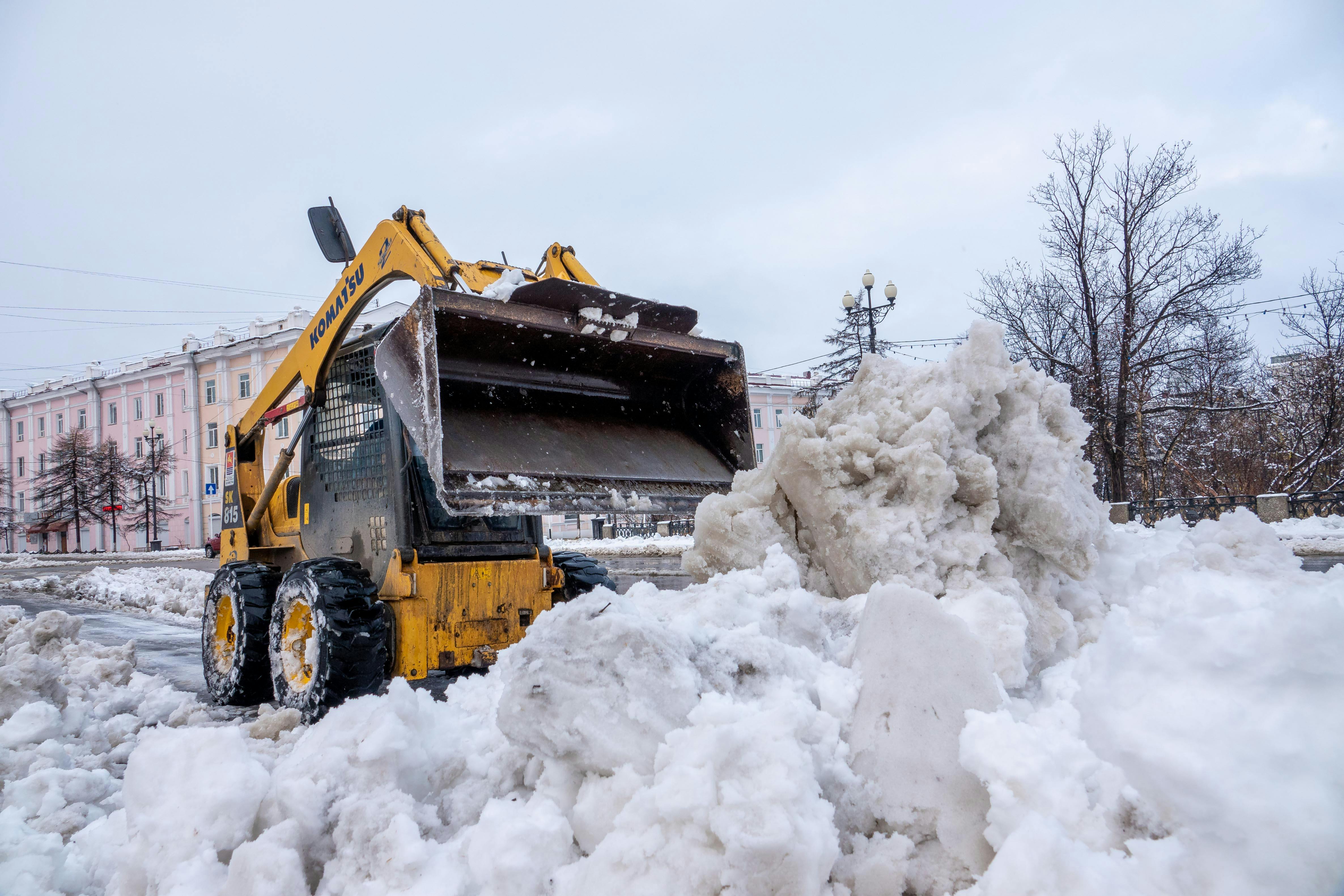 Commercial snow removal equipment clearing parking lot in Park City Utah